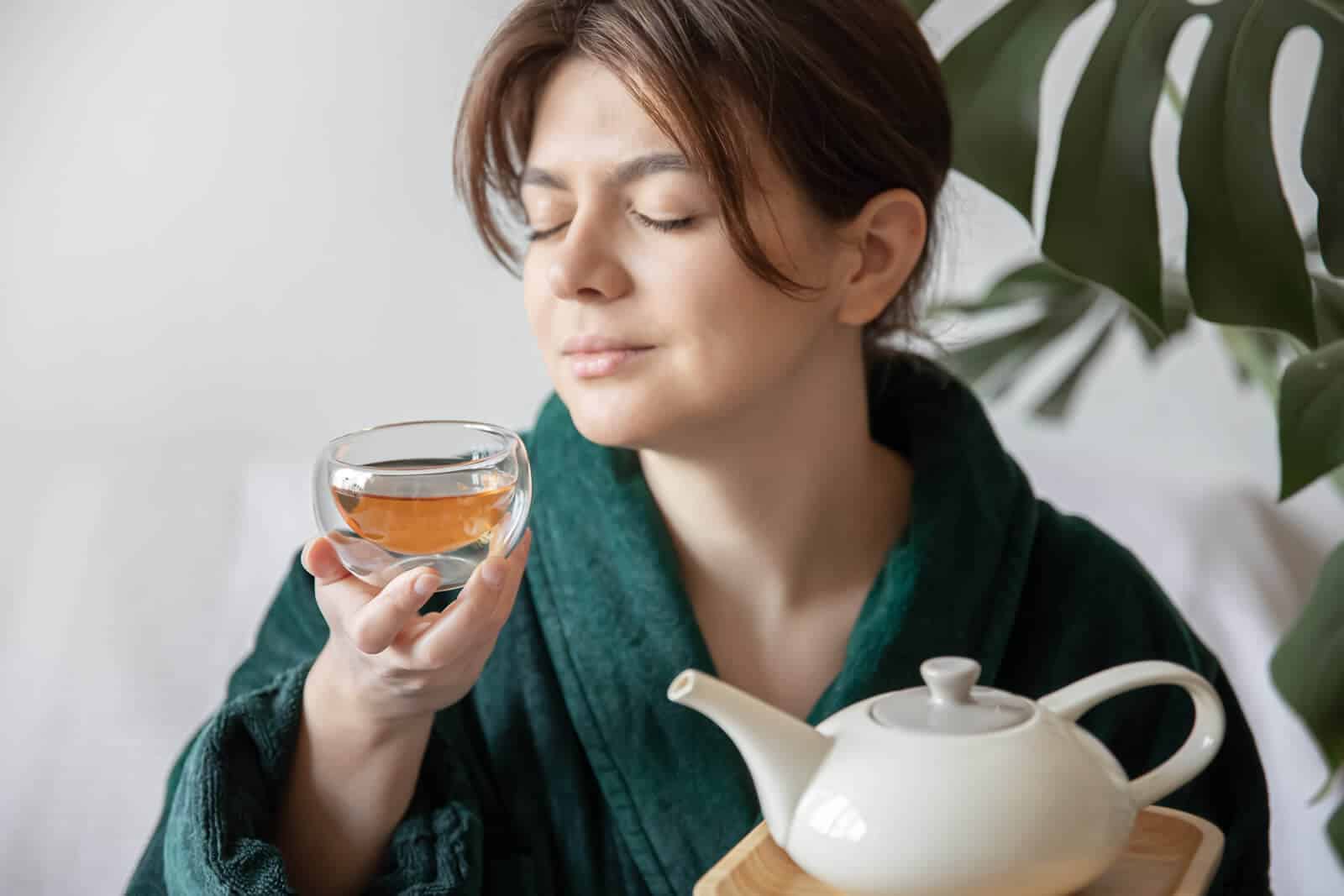 habits that support gut wellness. A lady drinking tea.